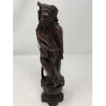 A finely carved wooden Chinese figure inlaid with cloisonne style wire work.