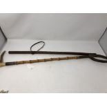 A horn handled riding crop with silver collar and leather clad military swagger stick.