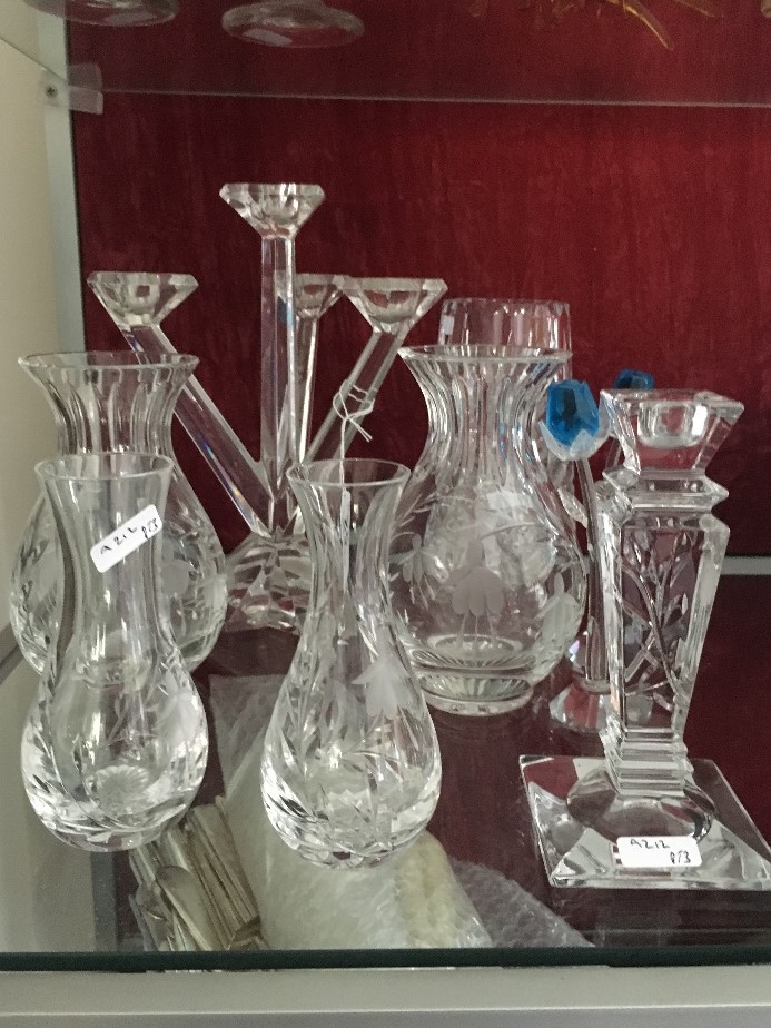 An assortment of crystal vases, candelabra, etc