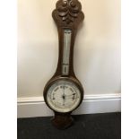 An oak cased combination barometer/thermometer.