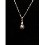 A 14ct white gold, South Sea pearl and diamond pendant on a silver chain.