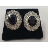 A large pair of silver, CZ and sapphire stud earrings.
