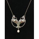 A silver Plique A Jour pendant necklace in the form of two peacocks, with pearl drop.