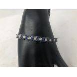 A fine 18K white gold sapphire and diamond tennis style bracelet.