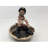 A Will Young Pottery figure - sailor in a coracle.