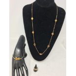 A set of 9ct gold and tiger's eye jewellery to include necklace, ring and bangle.