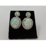 A pair of silver, CZ and opalite stud earrings.