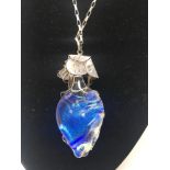 A fine silver and iridescent pendant necklace.