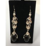 A pair of silver and onyx drop earrings.