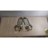 A pair of electric 19th Century style brass mirror backed wall sconces.