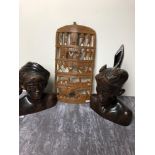 Two wooden carved busts possibly from Bali and an African carved wooden wall hanging.