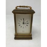 A brass carriage clock inscribed St. James London, 11 jewels to the case.