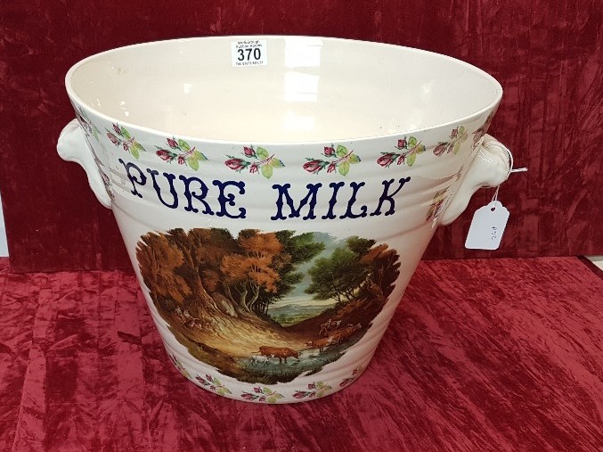 A ceramic twin handled milk pail.