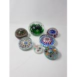 An assortment of 19th Century and later glass paperweights.