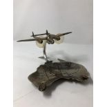 A chrome plated Lockheed Lightning P38 aicraft mounted on a map of Australia ashtray.