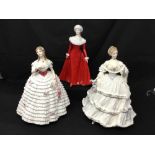 Three Royal Doulton figurines.