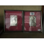 Two precious white metal engraved panels mounted in silk lined picture frames.