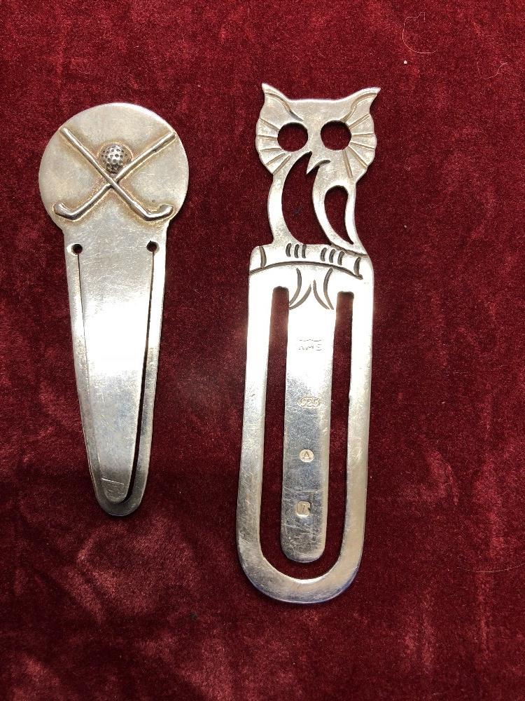 A silver book mark with an owl finial and a similar golfing book mark.