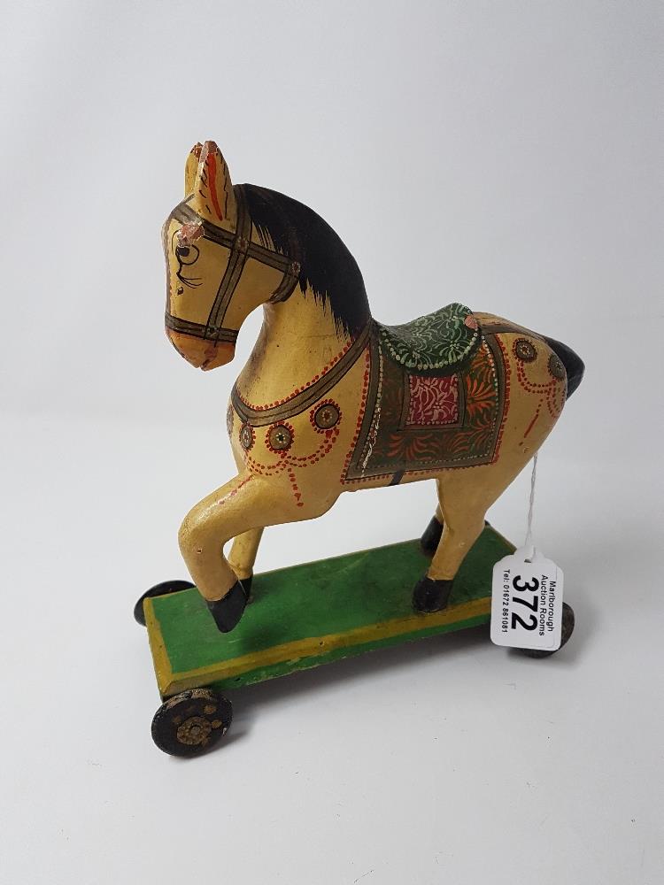 A contemporary painted model of a child's push along horse. - Image 2 of 2