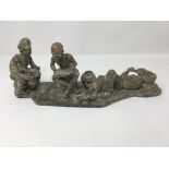 A fine African carved stone rustic sculpture of three assorted African figures in pose.