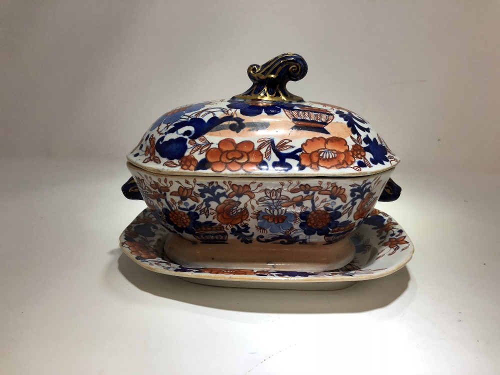 A 19th Century Imari pattern Mason's sauce tureen and cover with drip plate.