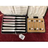 A cased set of six Art Deco silver fruit knives and a cased set of six coffee bean spoons.