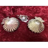 Two scallop shaped dishes and a silver mustard pot.