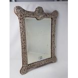 A large decorative 19th Century silver easel mirror with fine filigree decoration, on velvet.