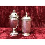 Two silver pepper shakers.