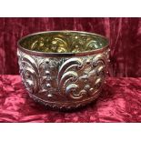 A silver gilt repousse bowl with foliate and phoenix decoration.