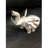 A cast silver figure of a bull elephant.