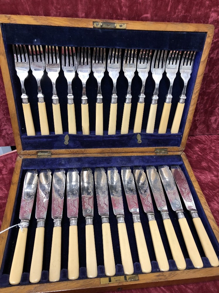 A wooden cased 24 piece silver collared fish cutlery set.