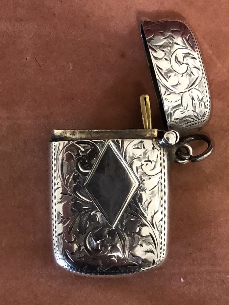 A silver vesta case with engraved decoration.