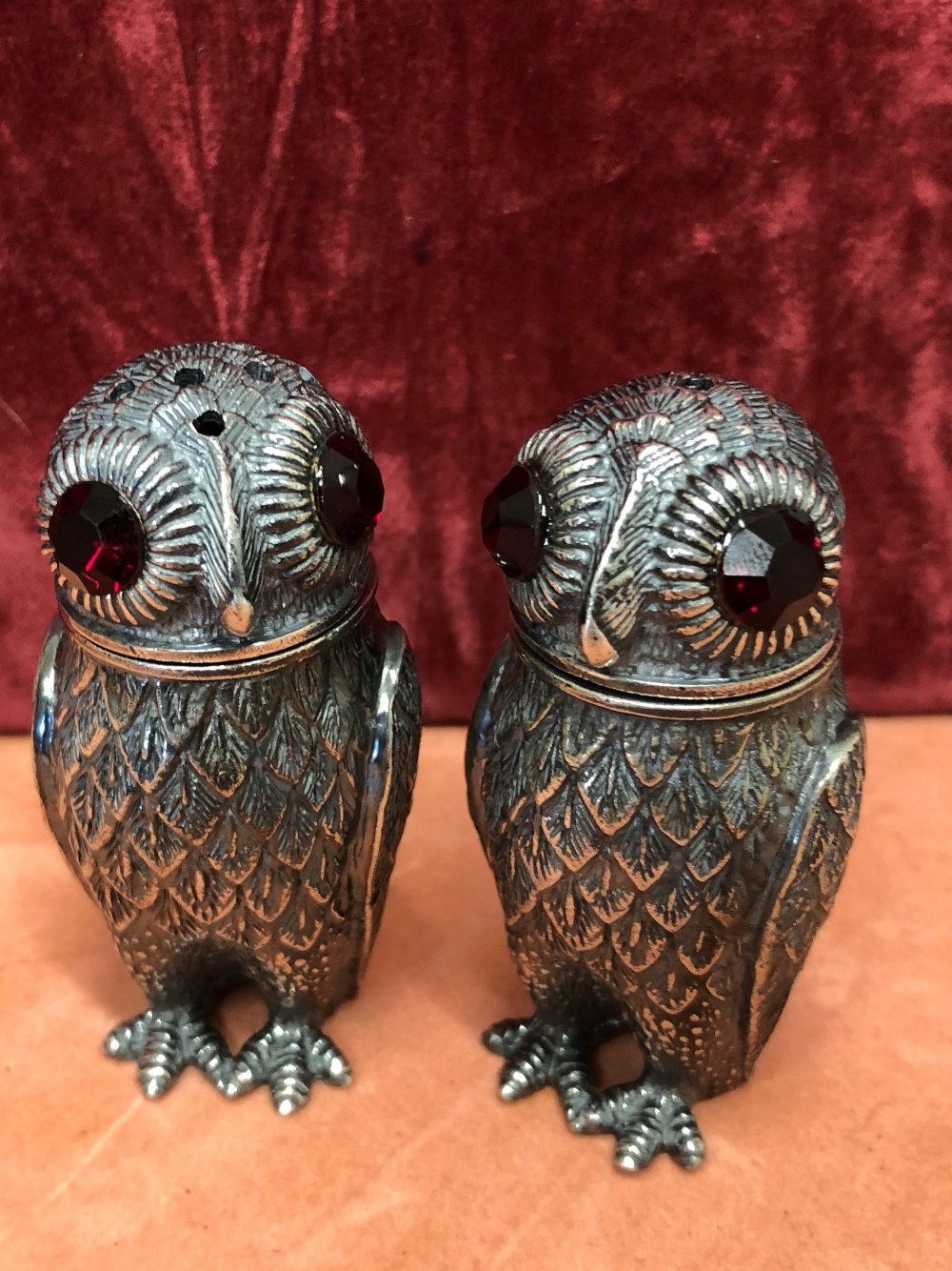 A pair of Continental silver novelty cruets in the form of owls.