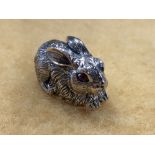 A silver figure of a rabbit with ruby eyes.