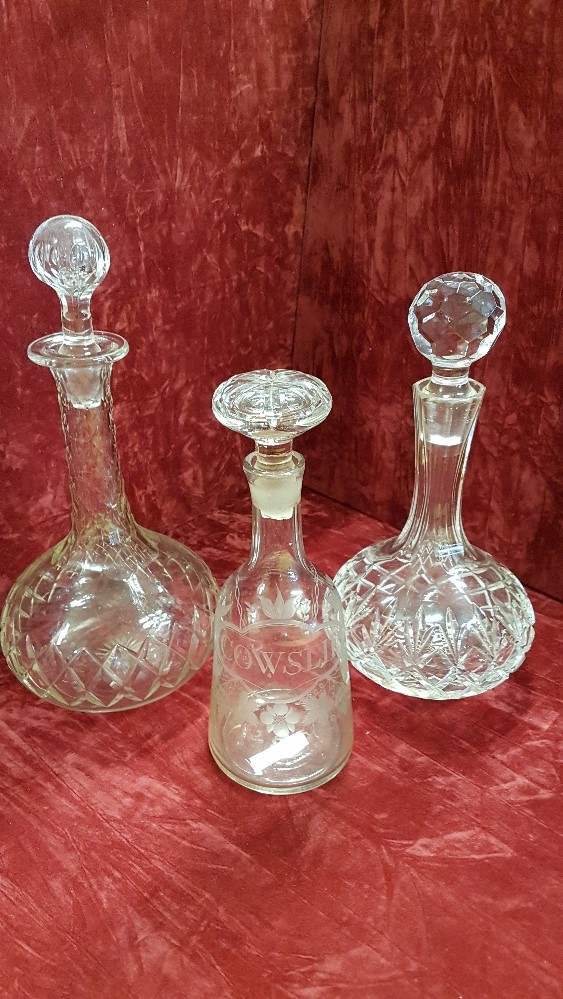 An early 20th Century glass decanter and two others.
