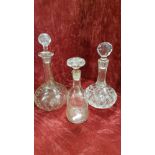 An early 20th Century glass decanter and two others.