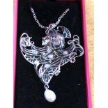 A silver Art Nouveau style pendant necklace.