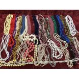 A box of assorted necklaces including from the 1950s.