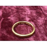 A 22ct gold wedding band.