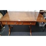 An Edwardian mahogany drop flap sofa table.