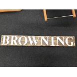 A large advertising sign for "Browning" (possibly from a gun shop).