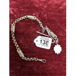 A Victorian Albert chain with white metal fob locket.