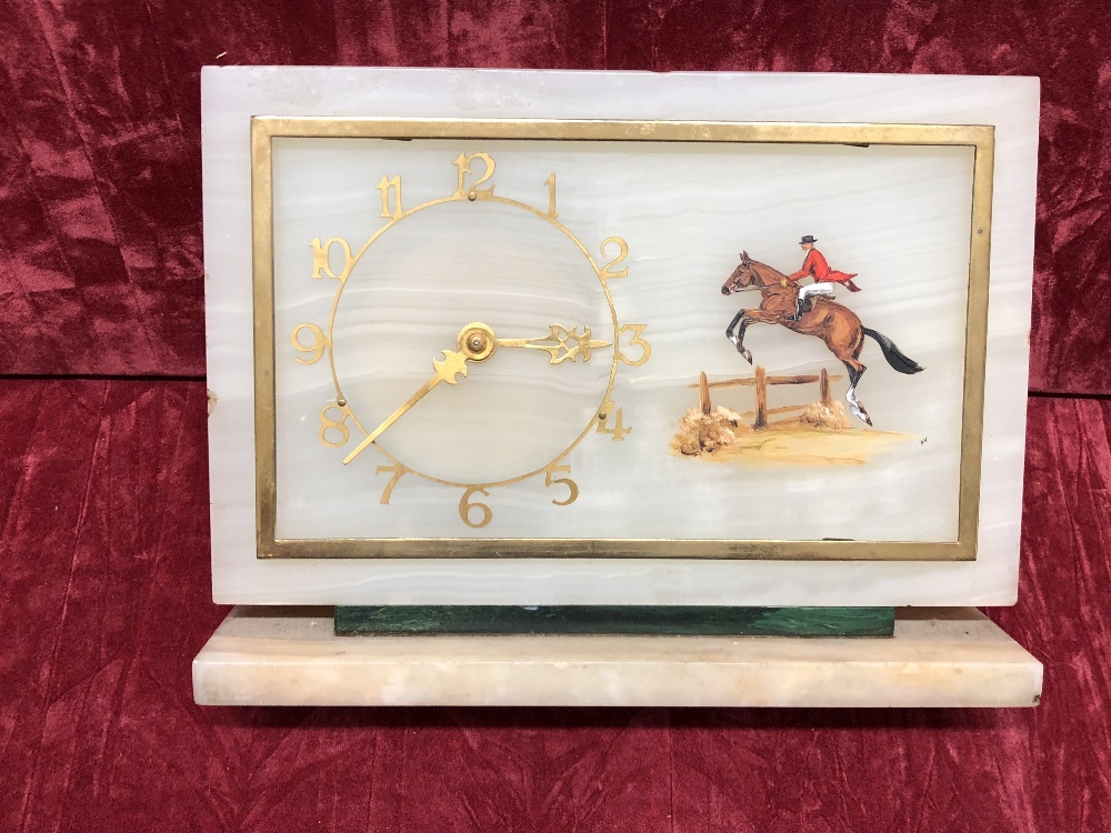 An alabaster mantel clock depicting a horse jumper with a malachite and marble base.