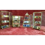 Four metal and glass table top display cabinets with 145 thimbles.