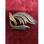 An Art Deco SHARMAINE Paris brooch of precious yellow metal set with marcasite.