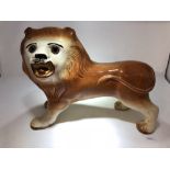 A 19th Century Staffordshire standing lion.