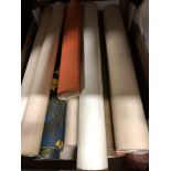 An assortment of vintage, mostly 1960s, wallpaper rolls.