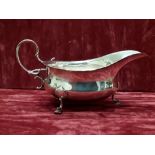 A silver George V sauce boat with three hoof supports.