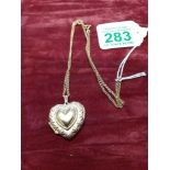 A 9ct gold heart shaped pendant on a 9ct gold chain.